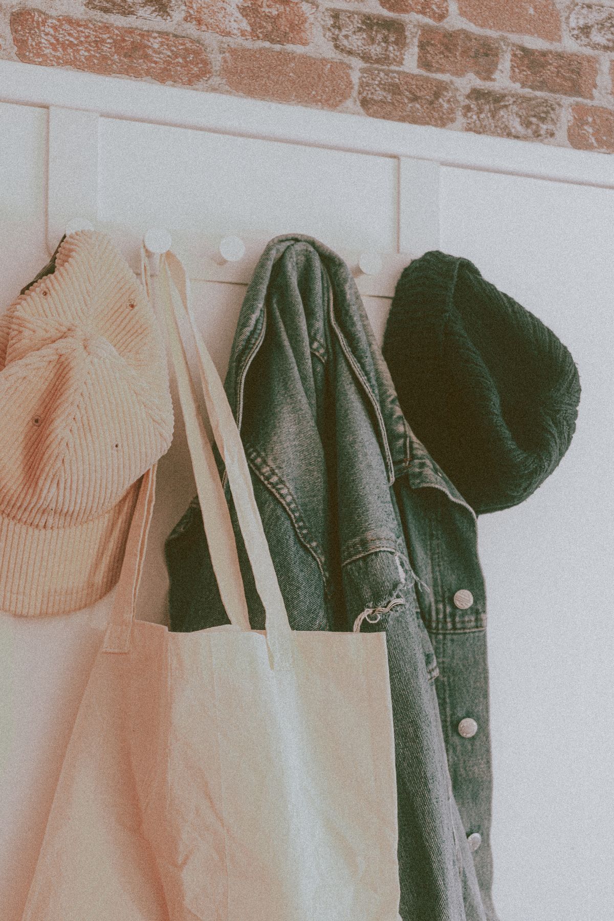 Organized entryway wall hooks with bags and clothing